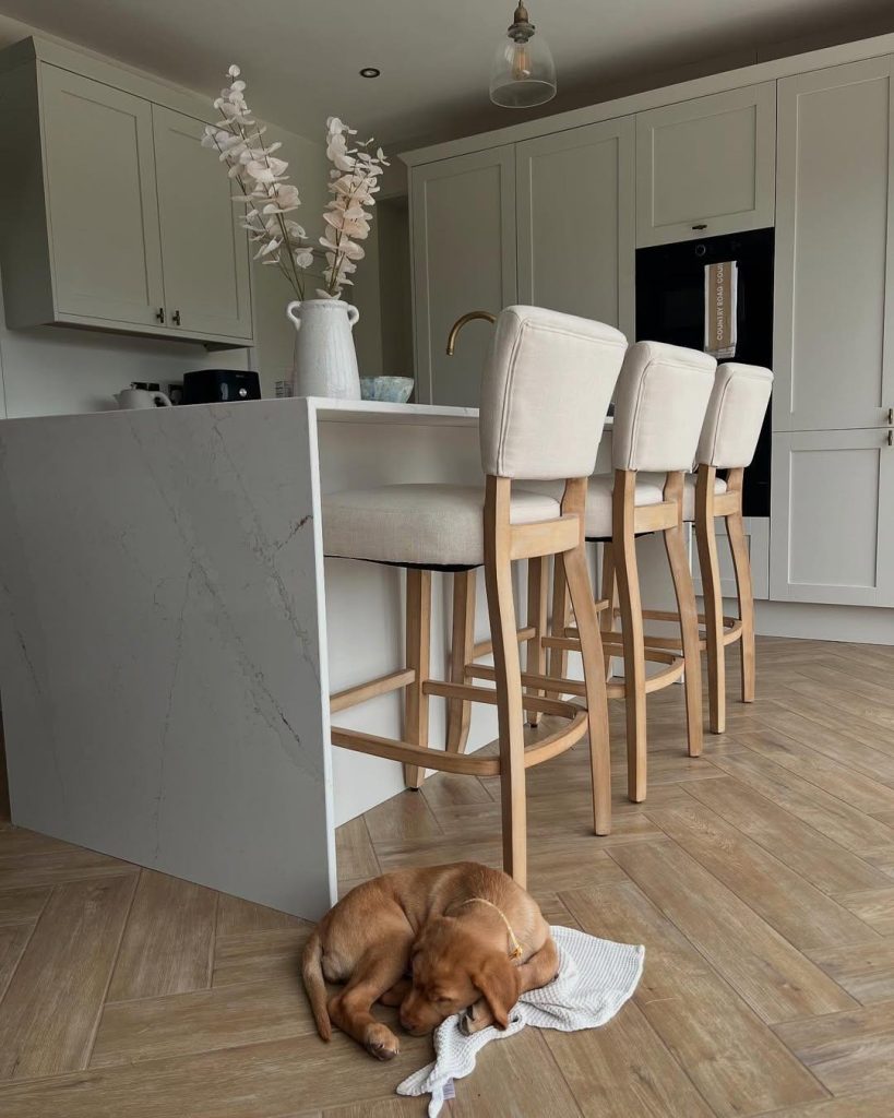 A waterfall edge done right: quiet veining, one continuous slab, no visual noise.